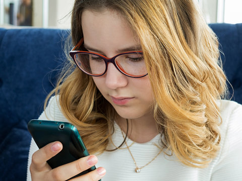 Teen Girl Looking At Mobile Phone