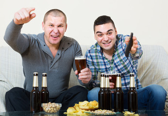 friends sitting at table with beer