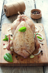 Raw whole chicken  on the wood table