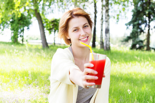 smiling girl  drinks juice