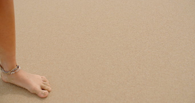 Bare Feet Coated in Sand Walking on Beach