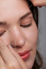 Woman during eyebrow threading