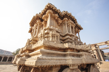 Naklejka premium A rich carved stone chariot inside the Vittala Hindu temple in the ancient site Hampi, Karnataka, India