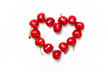 Fresh cherry heart isolated on white background