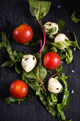 Fresh tomato and mozzarella salad on black slate