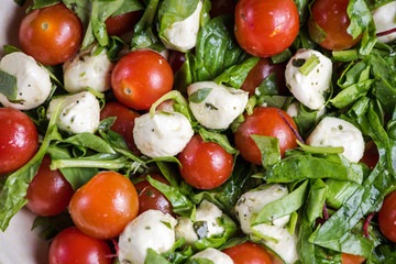 Italian style tomato and mozzarella salad in rustic bowl