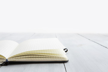 Notepad on white wooden background