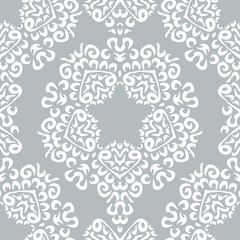 Seamless background made of exotic pattern in grey and white col