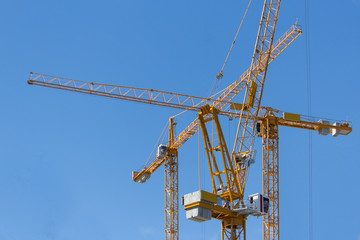 construction cranes on blue sky