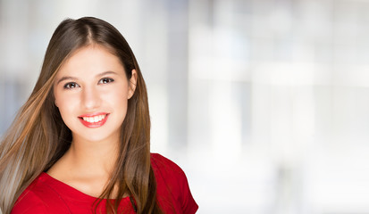 Portrait of a young smiling woman. Bright copy-space