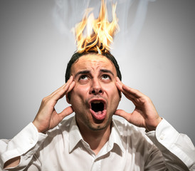 Shocked man watching his head burning