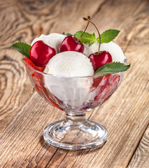 Ice cream with fruits and cherries on boards