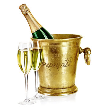 Bottle Of Champagne  In Ice Bucket With Stemware Isolated On Whi