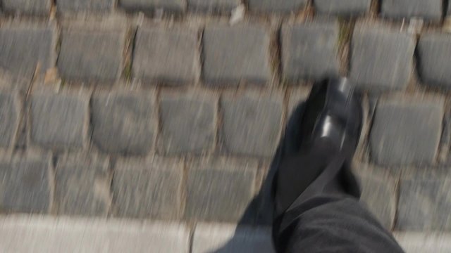 Man walking across the road - unique camera shot perspective