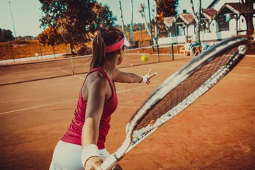 Tuinposter Young woman playing tennis © BalanceFormCreative