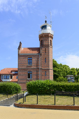 Old lighthouse in the harbor in Ustka, Poland. The building was built in 1892.