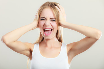 Fototapeta premium Closeup stressed woman covers ears with hands