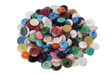 Pile of old colored buttons on white background