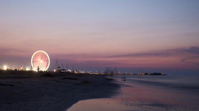 Ferris wheel in sunset on beach