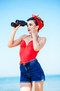 Pin-up at sea with binoculars, surprise expression