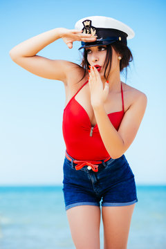 Pin-up at sea with captain hat