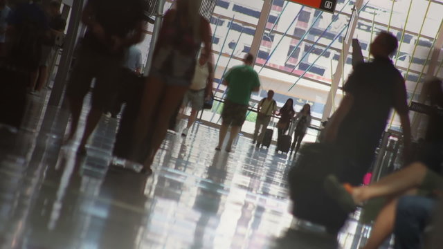 Airport Time Lapse Abstract - Canted time lapse shot of travelers with luggage, walking down an airport corridor