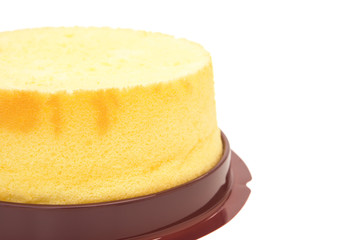 side view home made round sponge cake on white with clipping path and copy space