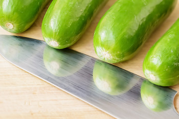 little cucumbers on the wooden board