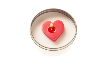 Heart shaped candle burning