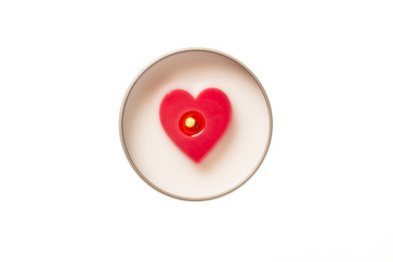Heart shaped candle burning