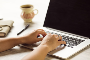 woman using laptop and on her table