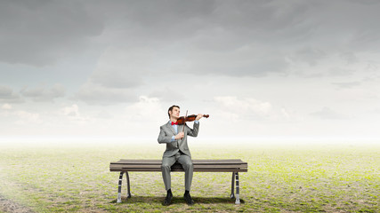 Businessman play violin