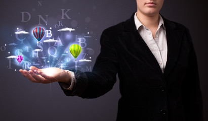 Letters and balloons in the hand of a businesswoman