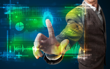 Young businessman pressing modern technology panel with finger p