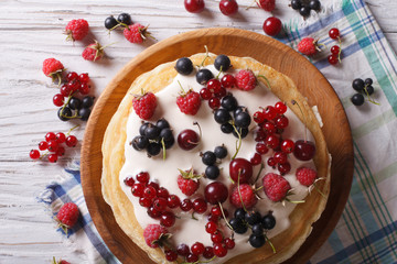 Crepes with berries and cream close-up. horizontal top view
