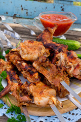 Skewers of meat rabbit on a wooden table