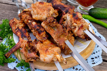 Skewers of meat rabbit on a wooden table