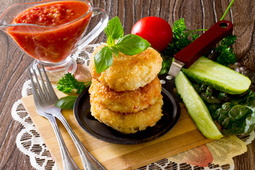 Vegetable burgers made from potatoes, corn and green peas on a wooden table
