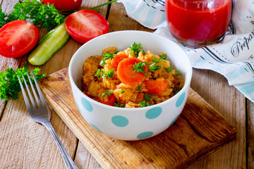 Braised cabbage with rice on a wooden table