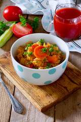 Braised cabbage with rice on a wooden table
