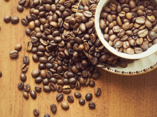 Cup with saucer and coffee beans on the table