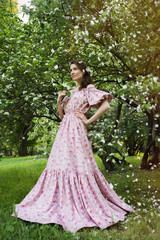 Fototapeta premium Young beautiful woman in the garden