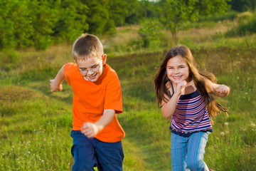 Happy children running at meadow