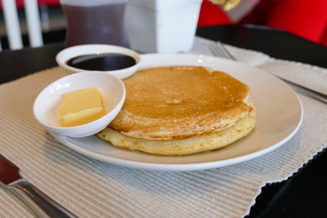 pancake serving with chocolate sauce and butter