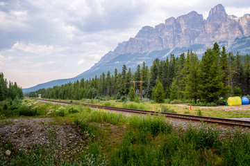 train track runs thru a beautiful mountain 