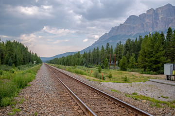 train track runs thru a beautiful mountain 