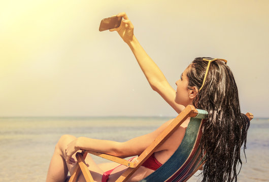 Girl doing a selfie at the beach