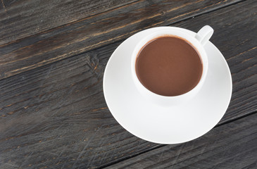 a cup of chocolate on wood table