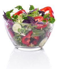 Glass bowl with vegetables for a salad on a white background wit