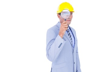 businessman with helmet and magnifier